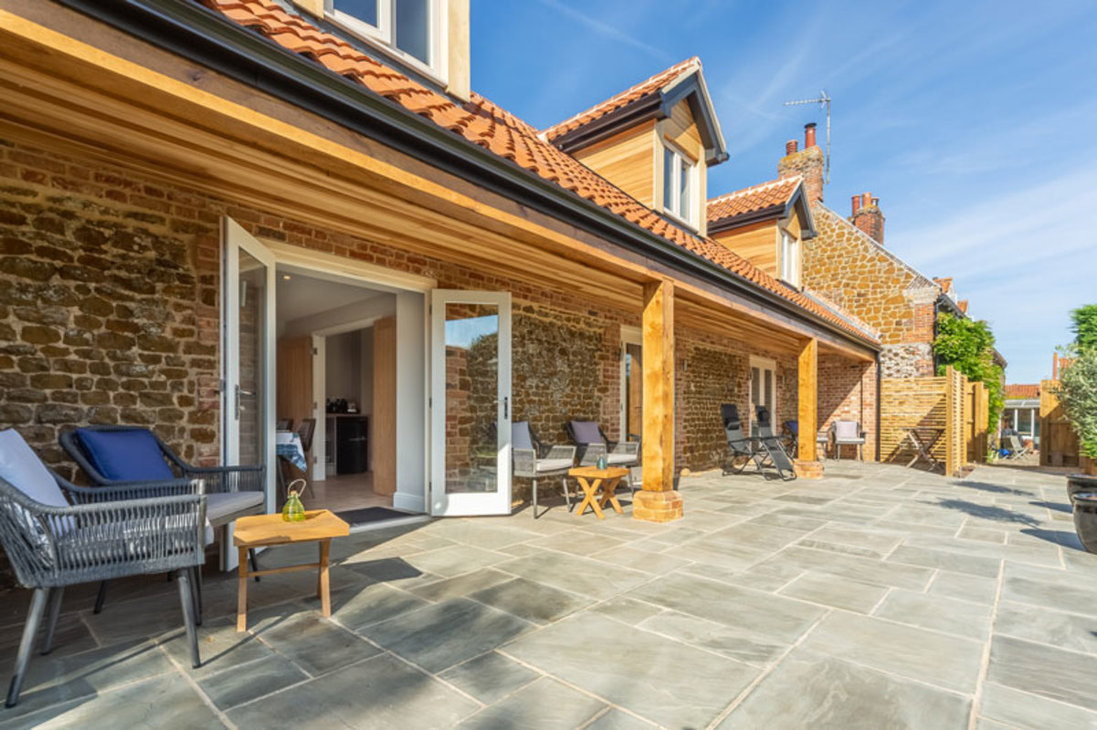 Carrstone Building with Patio and Timber Awning on Sunny Day in Old Hunstanton